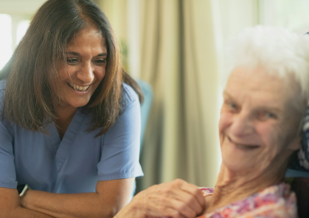 Healthcare caregiver supporting an older adult in a senior living setting